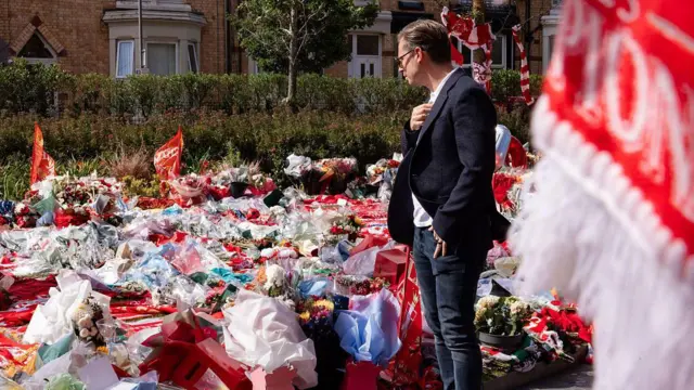 Michael Edwards observes the tributes to Jota and his brother outside Anfield