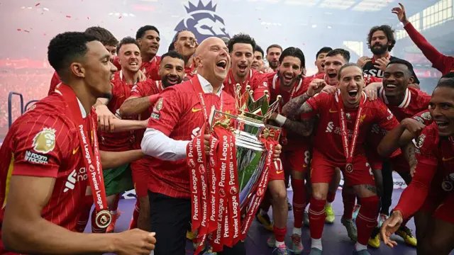 Arne Slot looking delighted with the Premier League trophy