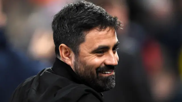 Swansea head coach Vitor Matos smiles on the touchline 