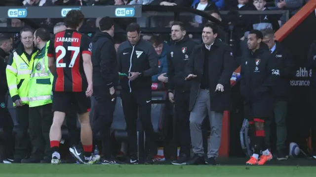 Illya Zabarnyi walks off the pitch after receiving a red card