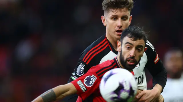 Tom Cairney challenges Bruno Fernandes