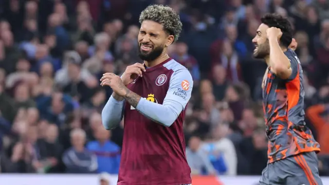 Douglas Luiz looks dejected