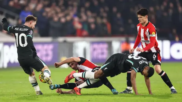 Brentford and Liverpool players challenge for the ball