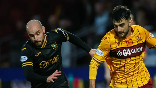 Livingston's Scott Pittman and Motherwell's Johnny Koutroumbis