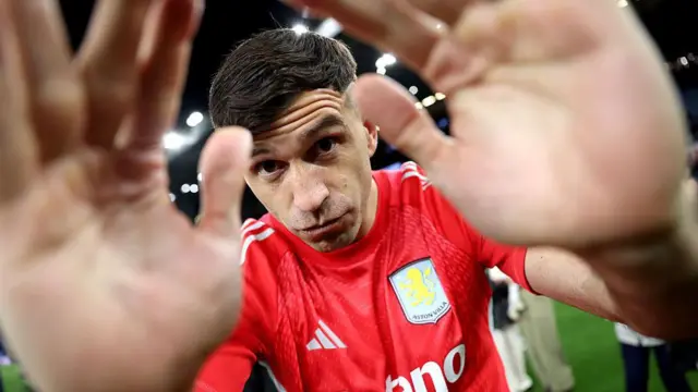 A close up image of Aston Villa's Emiliano Martinez putting his hands partly over the camera