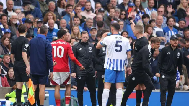 Morgan Gibbs-White of Nottingham Forest recieves a red card from Referee Robert Jones during the Premier League match between Brighton & Hove Albion FC and Nottingham Forest FC