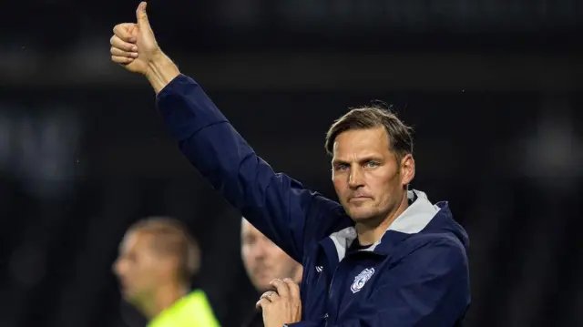 Darren Purse gives a thumbs-up to his players