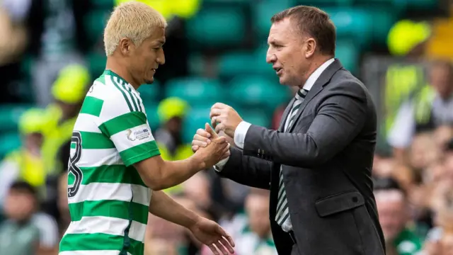 Celtic manager Brendan Rodgers (R) shakes the hand of Daizen Maeda as he is replaced during a Premier Sports Cup last sixteen match between Celtic and Hibernian at Celtic Park