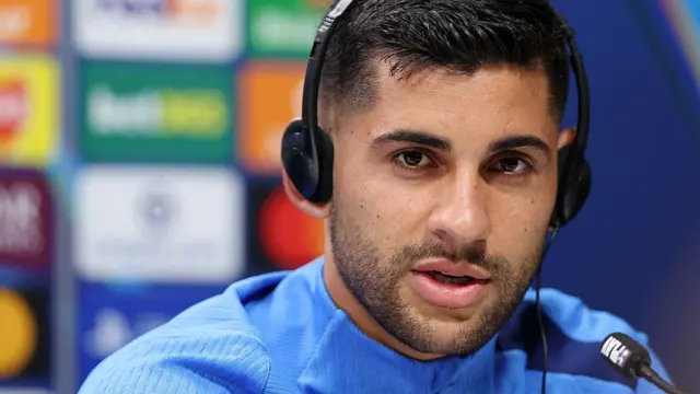 Cristian Romero of Tottenham Hotspur speaks to the media