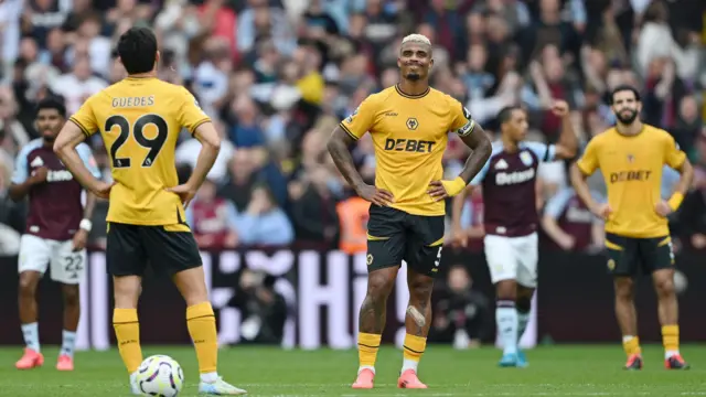 Wolves players Goncalo Guedes and Mario Lemina wait to kick off after conceding a goal at Aston Villa. 