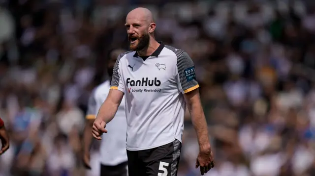 Matt Clarke playing for Derby County in their white and black home kit during a game against Sheffield United in May