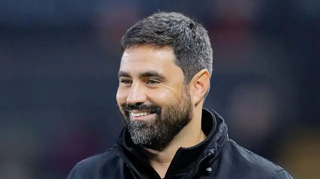 Vitor Matos smiles on the touchline 