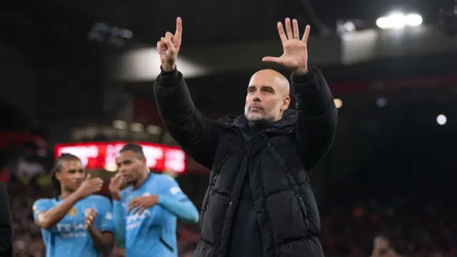 Manchester City manager Pep Guardiola holds up six fingers to the fans indicating the number of Premier League titles he has won after the Premier League match between Liverpool FC and Manchester City FC at Anfield