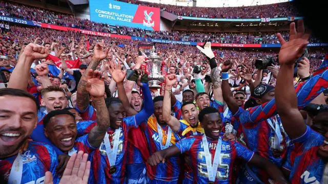 Crystal Palace players celebrate with the FA Cup and their fans