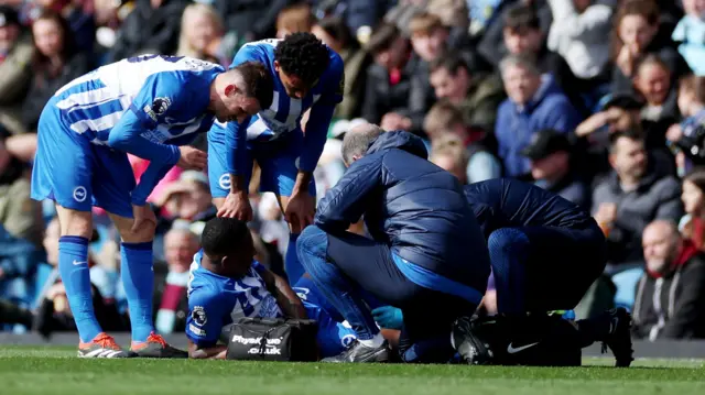 Brighton player receives treatment from medical staff