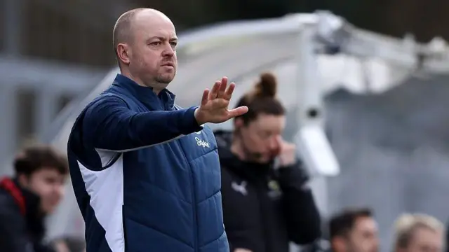 Everton interim boss Scott Phelan gestures with his arm outstretched.