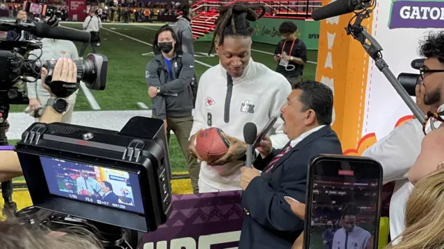 A media member speaks to DeAndre Hopkins on Super Bowl Opening Night in 2025