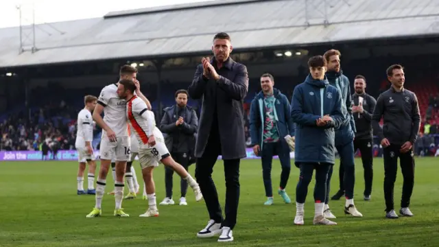 Rob Edwards, Manager of Luton Town, applauds the fans