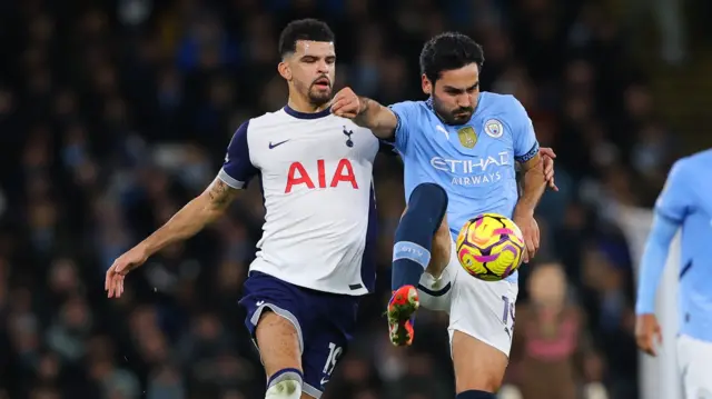 Dominic Solanke of Tottenham Hotspur battles for possession with Ilkay Gundogan of Manchester City