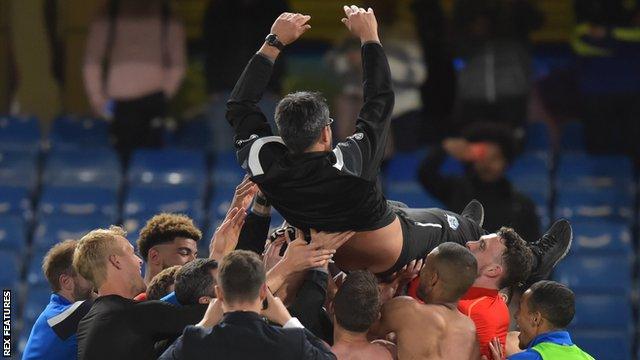 Huddersfield boss David Wagner is lifted into the air by his players after the Terriers secure Premier League survival