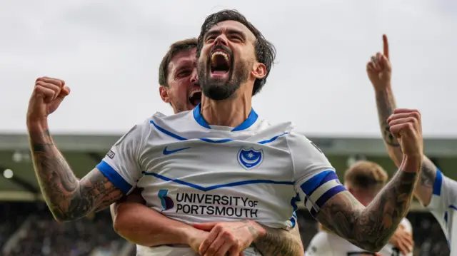 Marlon Pack celebrates Portsmouth's third goal at The Den
