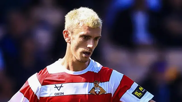 Zain Westbrooke playing for Doncaster last season, with bleach blond hair