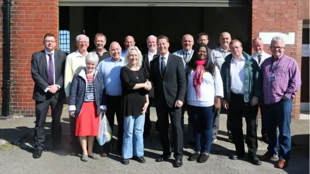 Council Leader Ronnie Nicholson with Moxie DePaulitte and Tabitha Mudaliar of Dumfries and Galloway Refugee Action and Dumfries and Galloway Councillors at Marchmount Depot in Dumfries.