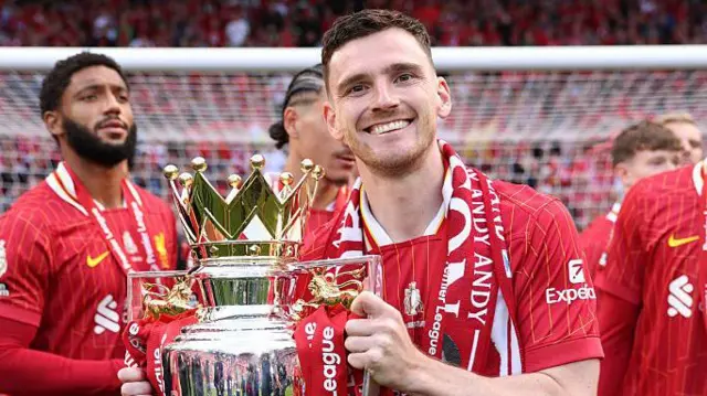 Andy Robertson holding the Premier League trophy for Liverpool