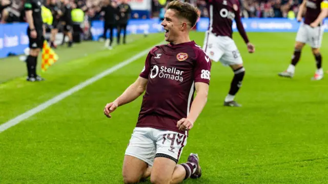 Cammy Devlin celebrates after scoring for Hearts against Falkirk