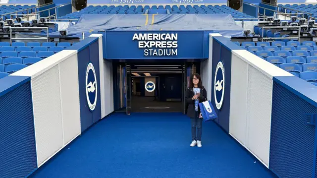 A lady stands in the tunnel at American Express Stadium