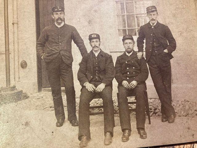 An old photograph of four lighthouse keepers outside the Corsewall Lighthouse in 1892.