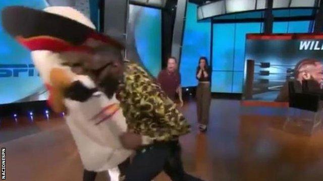 Deontay Wilder punching a mascot on a live American TV show.