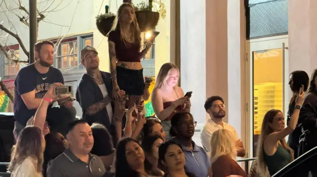 People waiting outside a New Orleans restaurant hoping to catch a glimpse of Taylor Swift