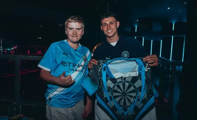 Phil Foden meets darts fan Alex