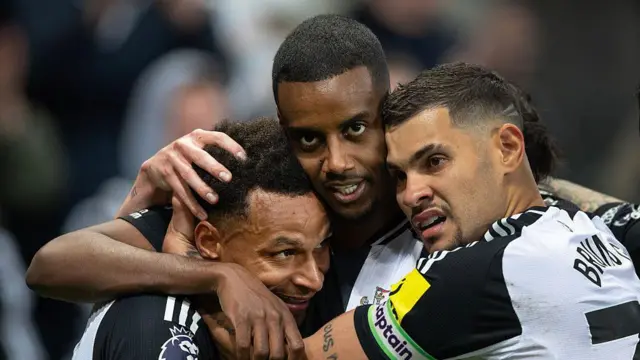 Alexander Isak hugs Bruno Guimaraes and Jacob Murphy when celebrating for Newcastle