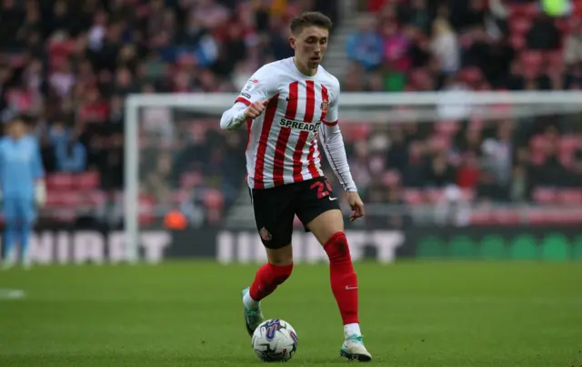 Dan Neil dribbling with a football.