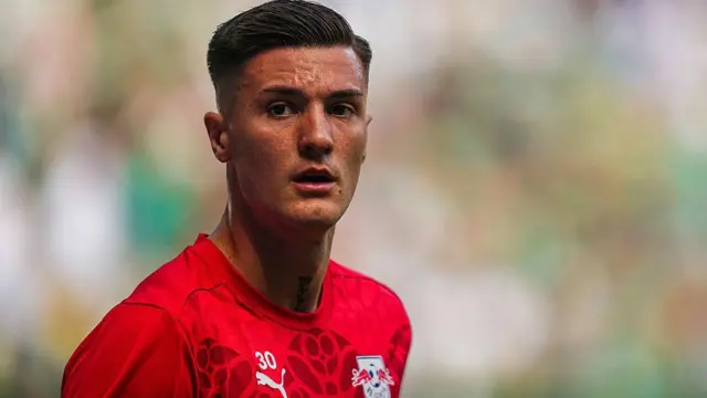 Benjamin Sesko looks on for RB Leipzig in red away kit