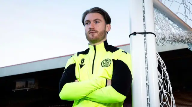 Callum Slattery poses for pictures at Fir Park