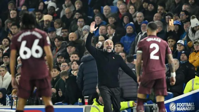 Pep Guardiola shouts instructions to his players from the touchline