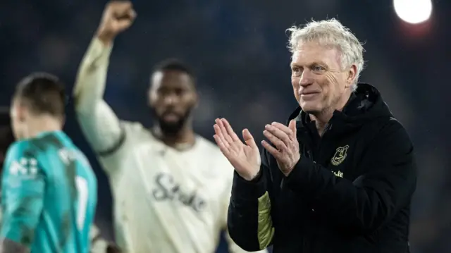 David Moyes applauds fans while players celebrate in background