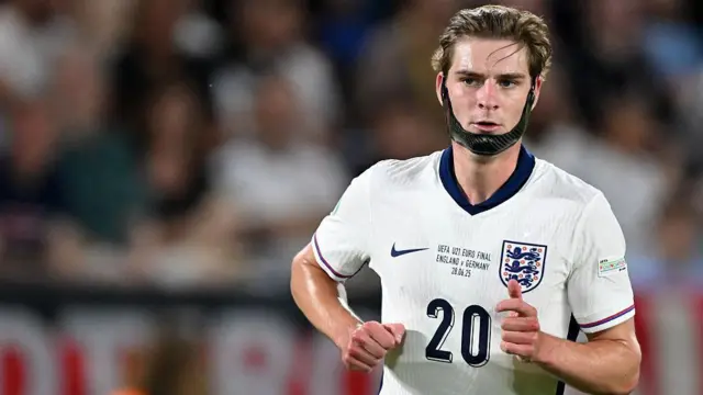 Alex Scott playing for England Under-21s with his chin strap to protect his fractured jaw