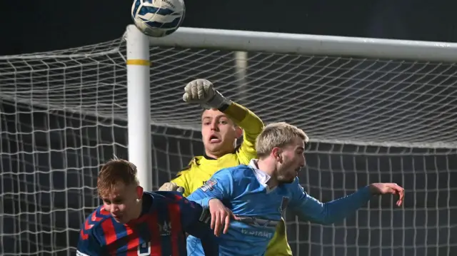 Ards keeper Marc Matthews punches the ball clear during Saturday's match