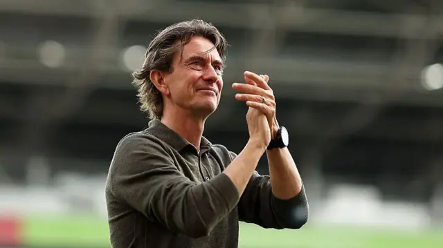 Thomas Frank applauds after match
