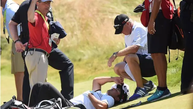 Jason Day lays on the green