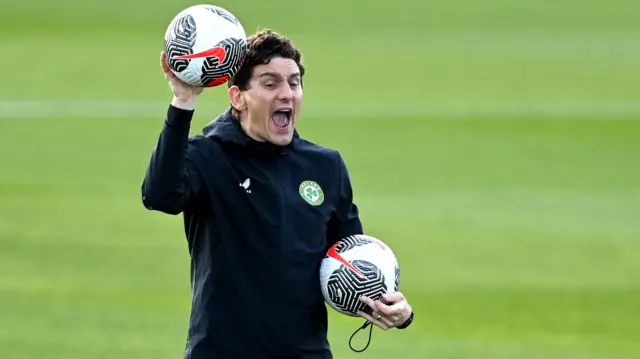 Keith Andrews carrying two footballs during a Republic of Ireland training session