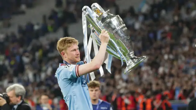 Kevin De Bruyne holding the Champions League trophy