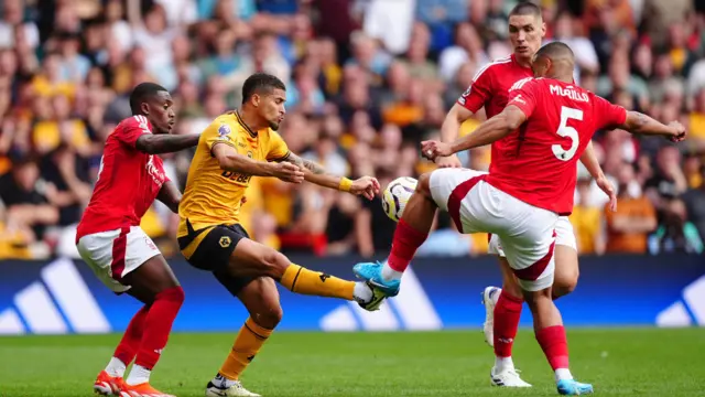 Wolverhampton Wanderers' Joao Gomes (centre) battles with Nottingham Forest's Callum Hudson-Odoi 