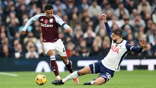 Jacob Ramsey is tackled by Rodrigo Bentancur