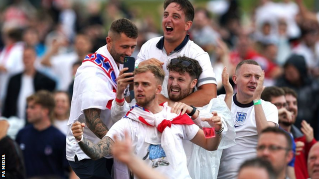 Fans in Manchester react after Manchester United's Harry Maguire scores England's second goal