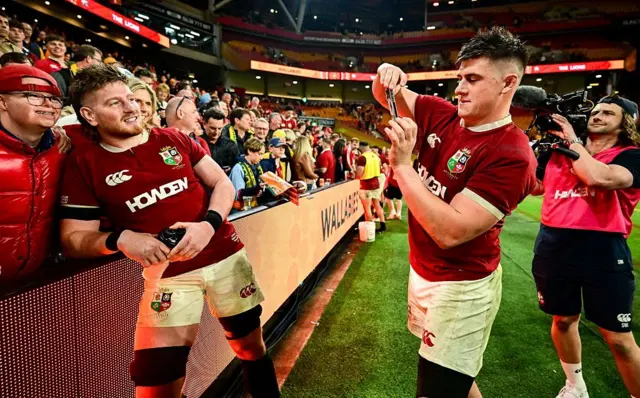 Dan Sheehan of British & Irish Lions, right, takes a photo of teammate Joe McCarthy with his brother Andrew after the first test.